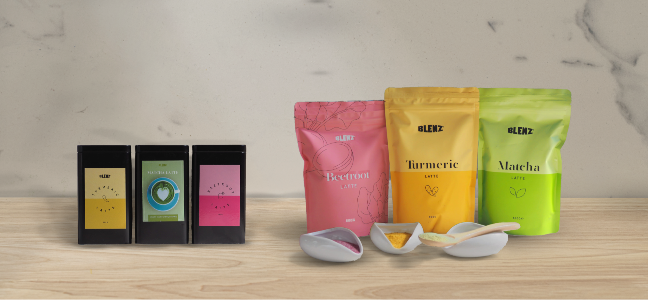 Bags and tins of Matcha, Beetroot and Turmeric Latte powder on a kitchen bench