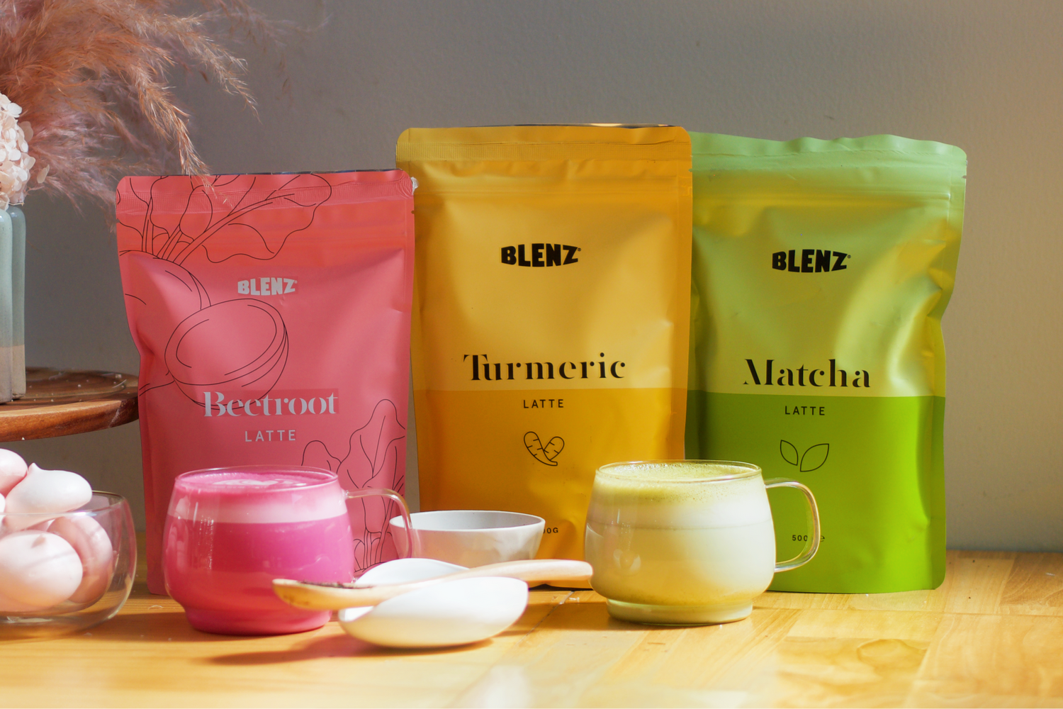 bags of Beetroot, Turmeric and Matcha Latte powder and lattes on bench